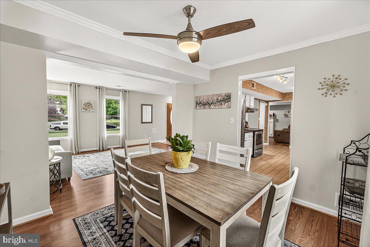 19624 Westerly Avenue Poolesville, MD 20837 - Photo 13 of 44 a dining room with furniture a chandelier and wooden floor