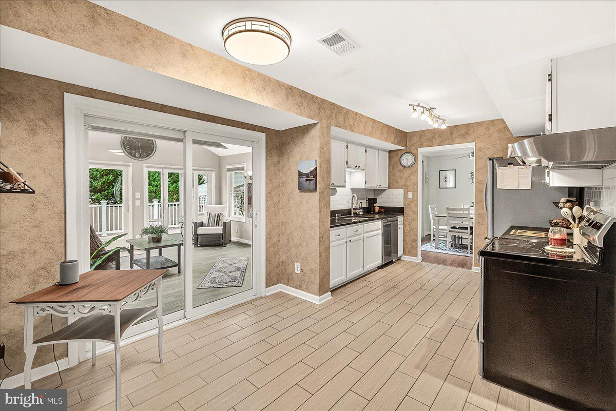 19624 Westerly Avenue Poolesville, MD 20837 - Photo 17 of 44 a kitchen with stainless steel appliances kitchen island granite countertop a sink and cabinets