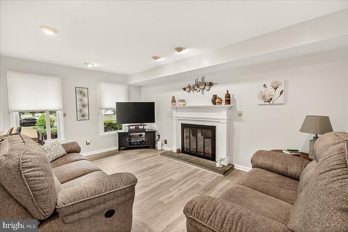 19624 Westerly Avenue Poolesville, MD 20837 - Photo 20 of 44 a living room with furniture a flat screen tv and a fireplace