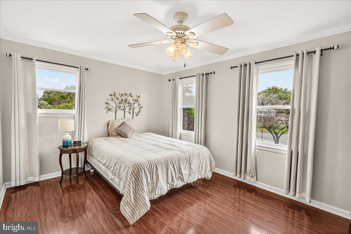 19624 Westerly Avenue Poolesville, MD 20837 - Photo 23 of 44 a bedroom with a large bed and a chandelier