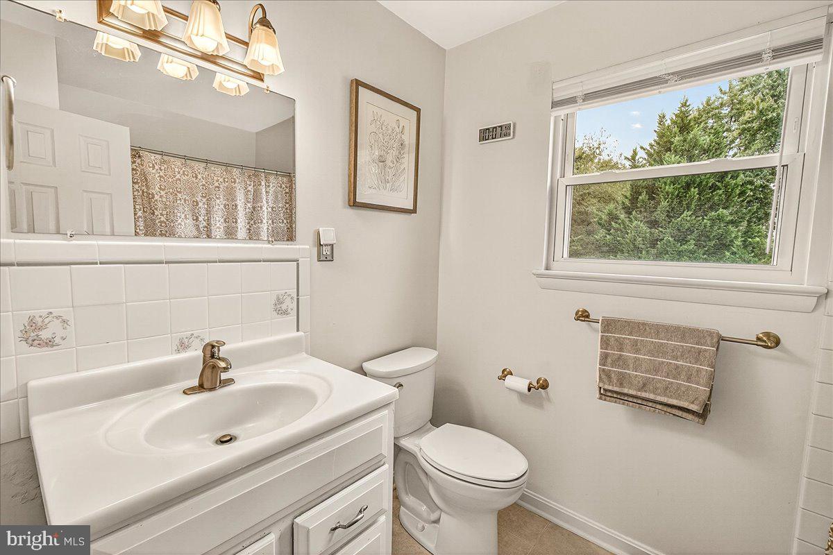 19624 Westerly Avenue Poolesville, MD 20837 - Photo 24 of 44 a bathroom with a sink a mirror and a toilet