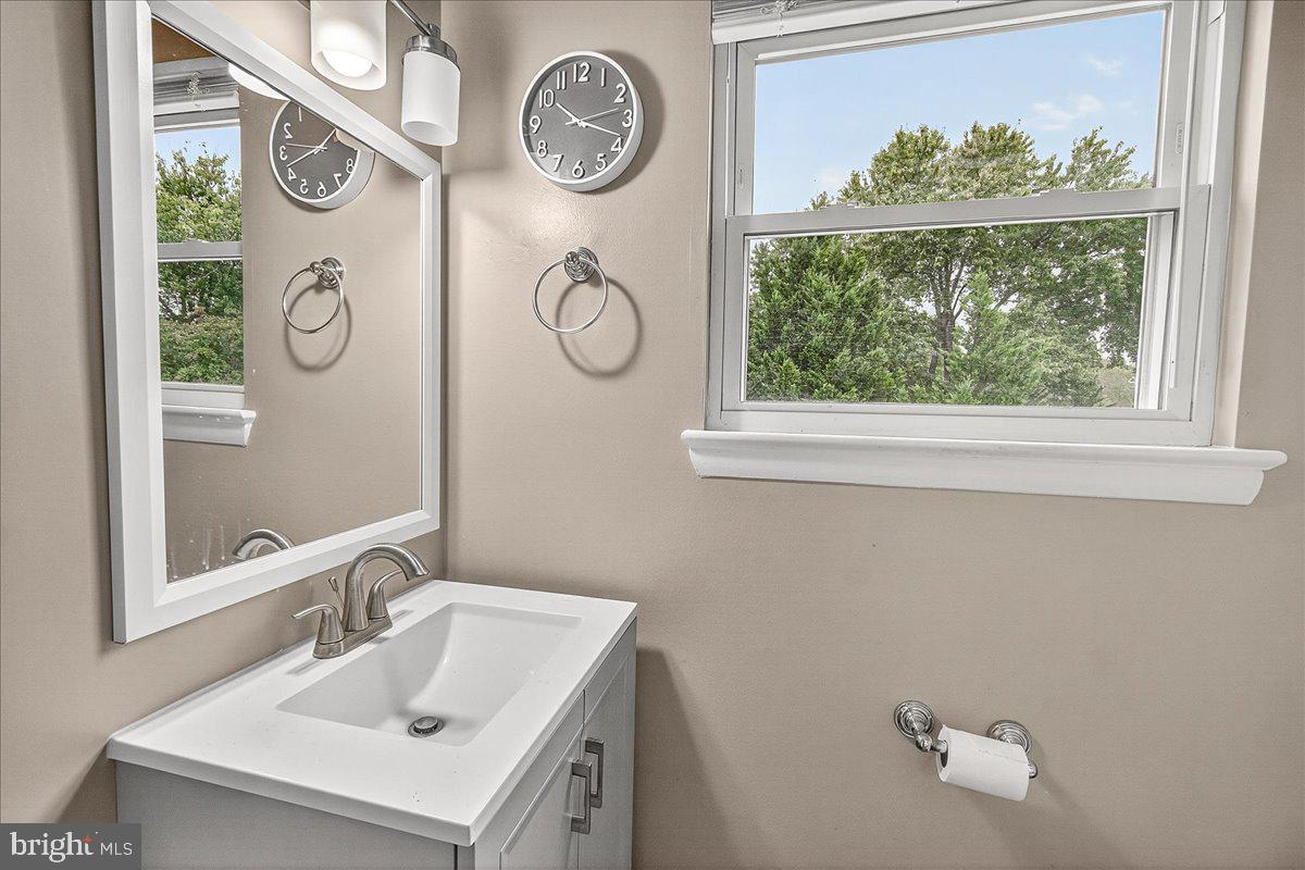 19624 Westerly Avenue Poolesville, MD 20837 - Photo 26 of 44 a bathroom with a sink and a mirror