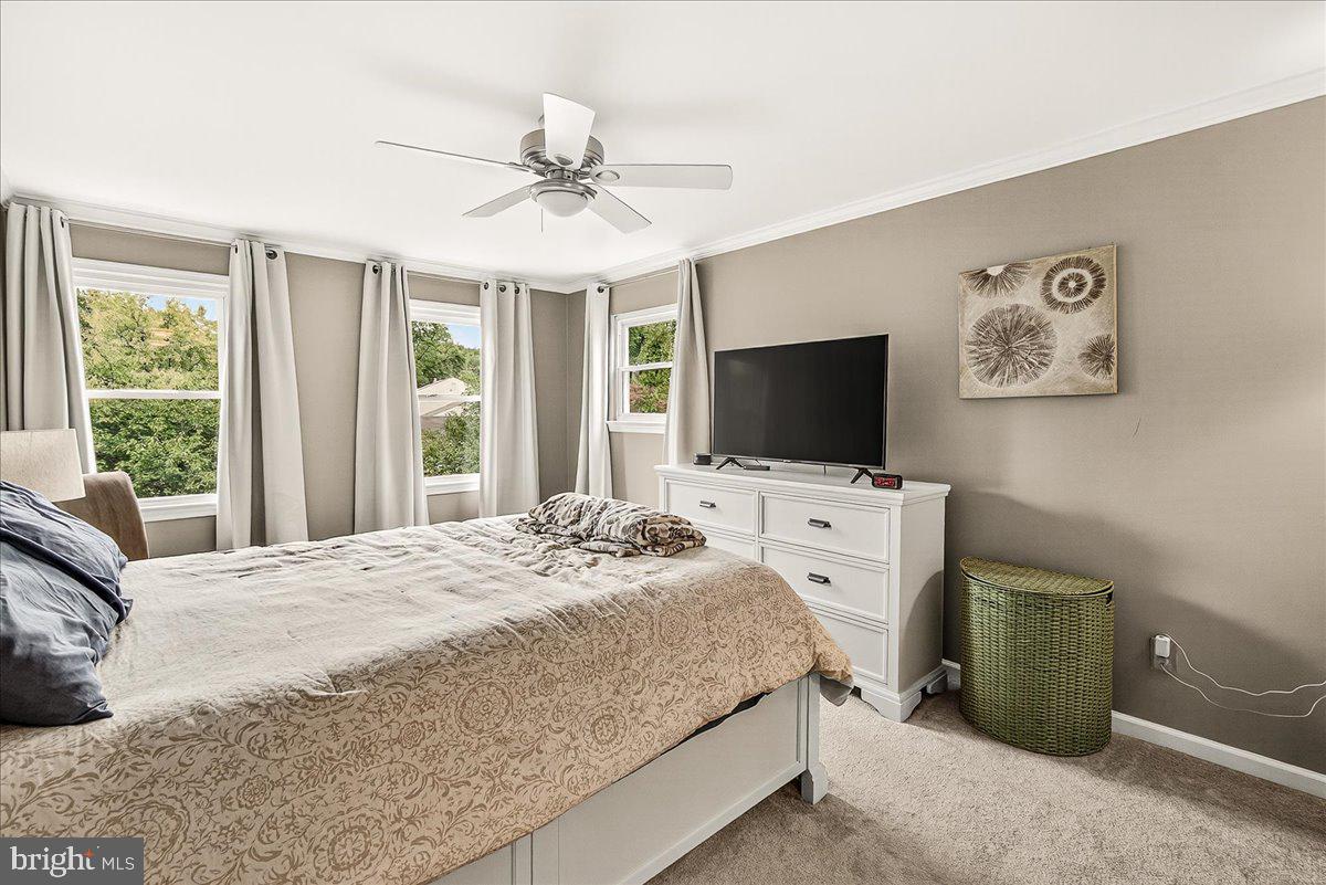 19624 Westerly Avenue Poolesville, MD 20837 - Photo 27 of 44 a bedroom with a large bed and a flat tv screen on dresser