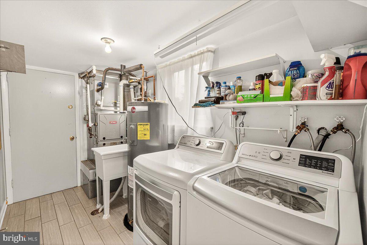 19624 Westerly Avenue Poolesville, MD 20837 - Photo 32 of 44 a utility room with dryer washer and a view of living room