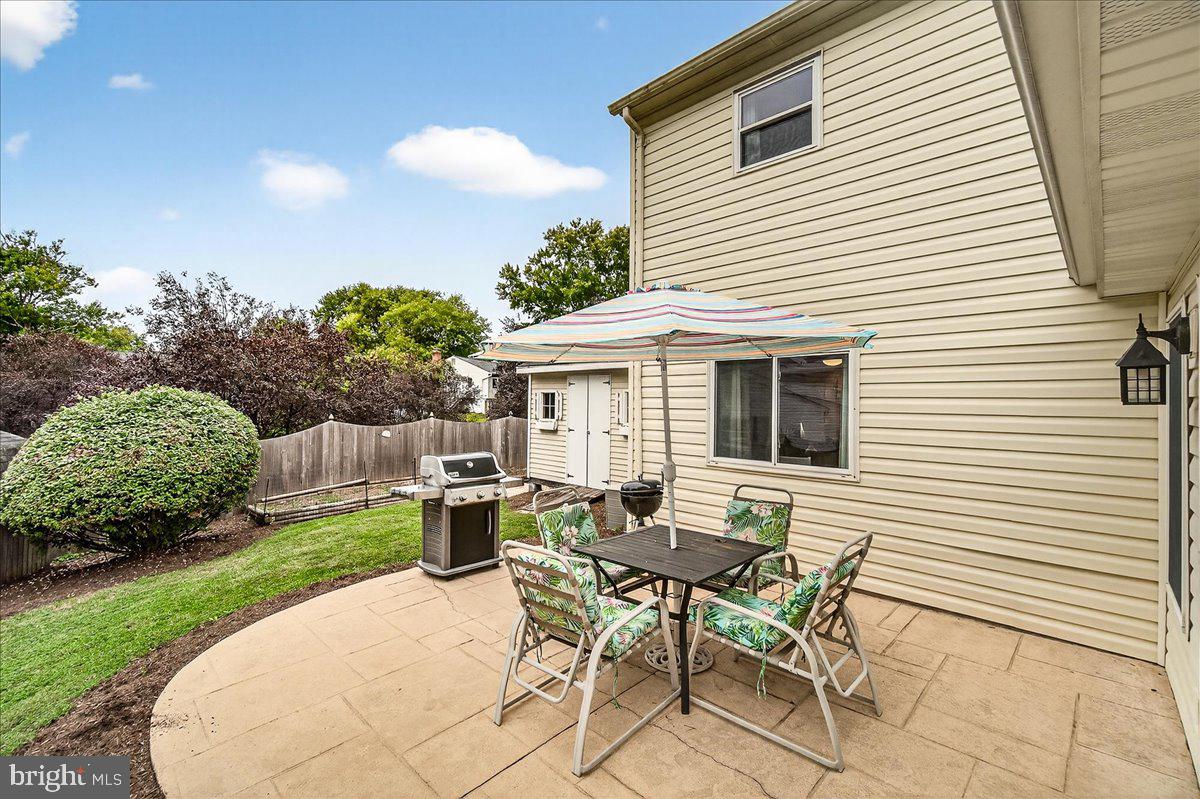 19624 Westerly Avenue Poolesville, MD 20837 - Photo 33 of 44 a patio with table and chairs and potted plants
