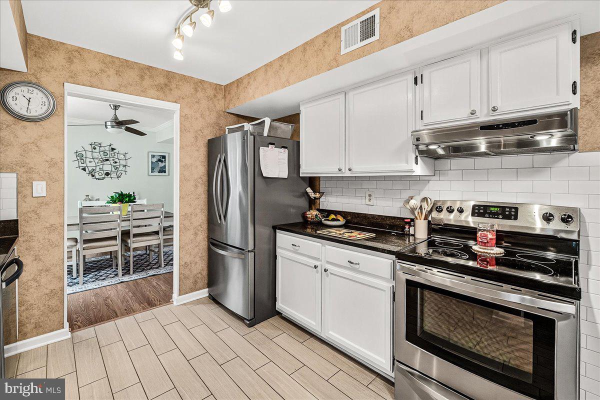 19624 Westerly Avenue Poolesville, MD 20837 - Photo 8 of 44 a kitchen with stainless steel appliances a stove a sink and a refrigerator