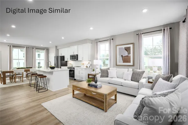 a living room with furniture wooden floor and a large window