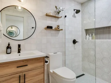 a bathroom with a sink a toilet and a mirror