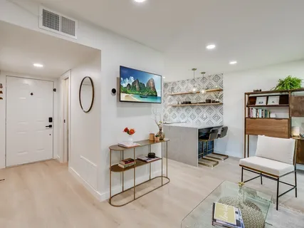 a living room with furniture and a clock