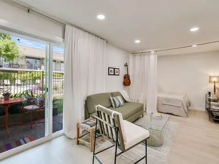 a living room with furniture and a floor to ceiling window