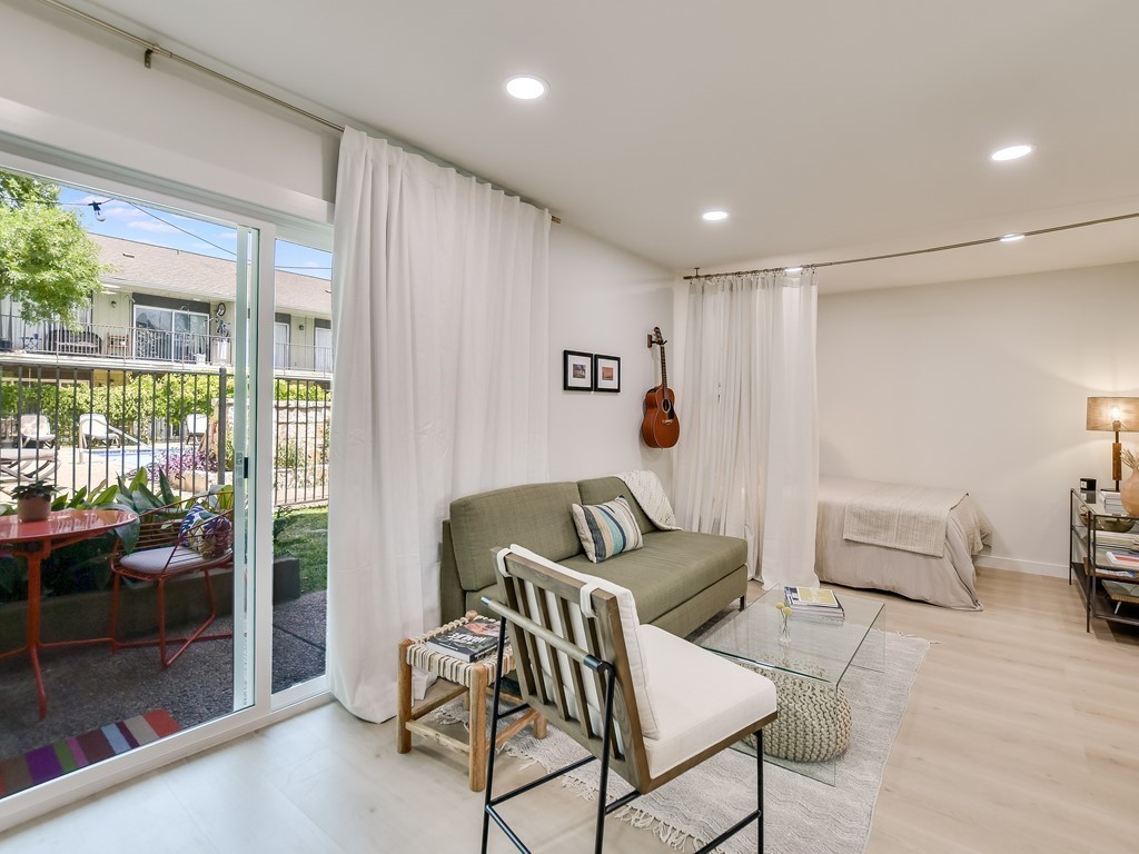 500 East Riverside Drive, Unit 169 Austin, TX 78704 - Photo 5 of 19 a living room with furniture and a floor to ceiling window