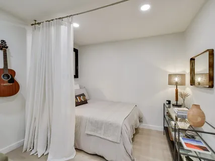 a bedroom with a bed and a lamp on the table