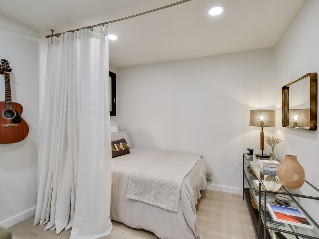 500 East Riverside Drive, Unit 169 Austin, TX 78704 - Photo 6 of 19 a bedroom with a bed and a lamp on the table