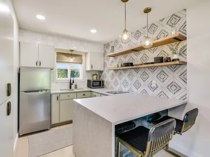 a kitchen with a sink appliances and cabinets