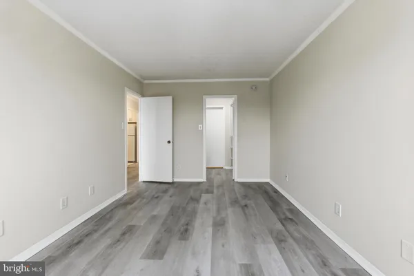 a view of an empty room with wooden floor