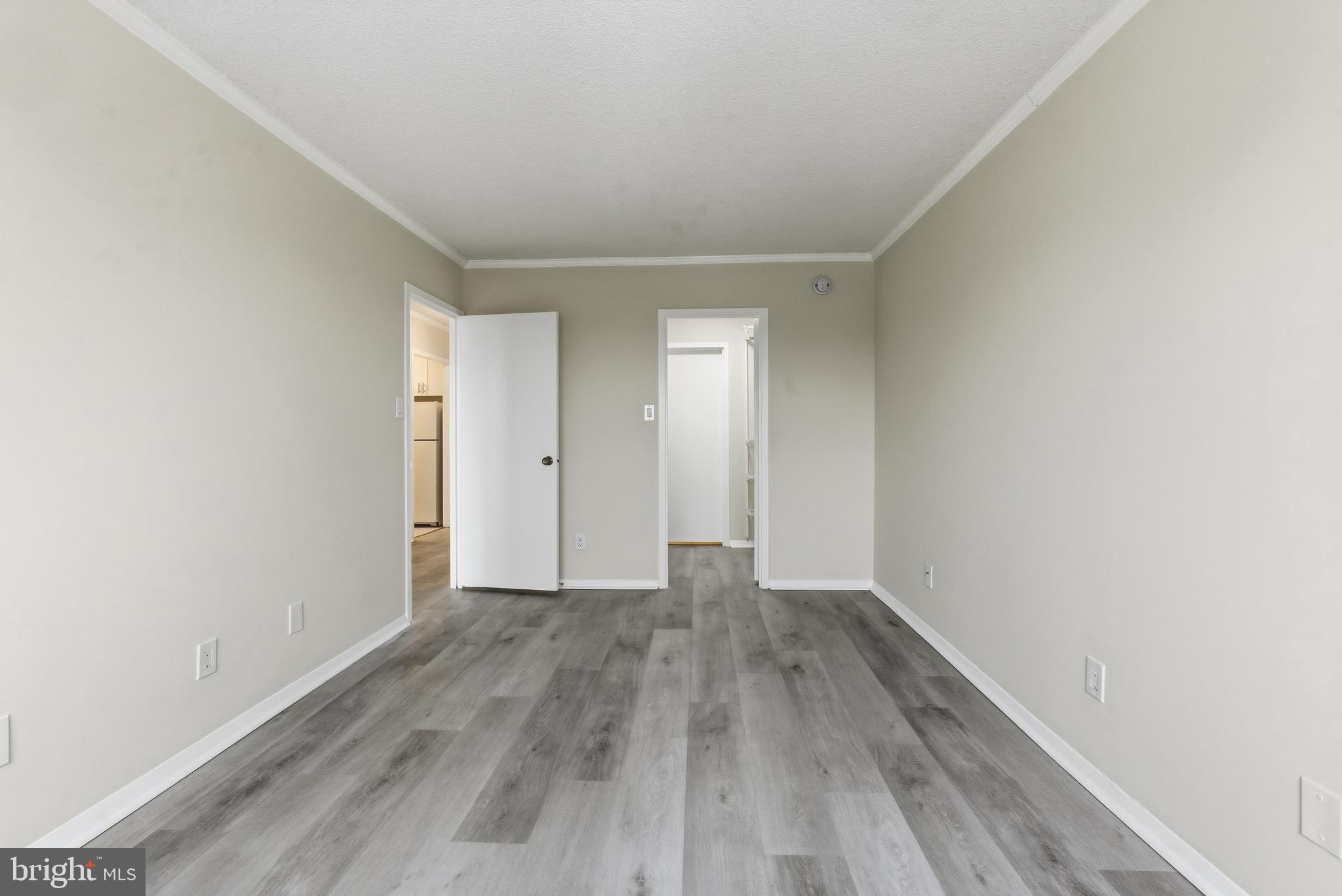 5225 Pooks Hill Road, Unit 1206S Bethesda, MD 20814 - Photo 2 of 12 a view of an empty room with wooden floor