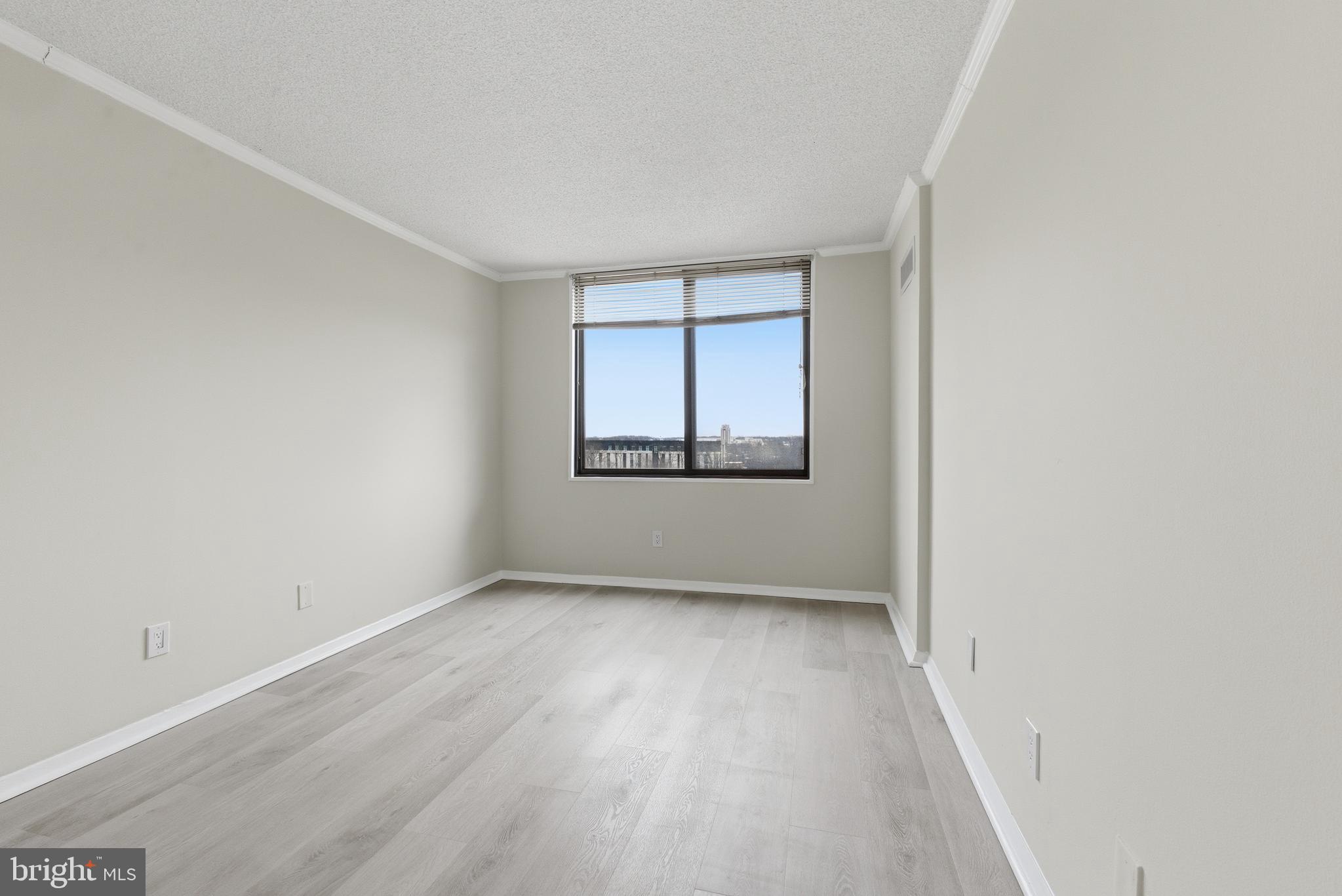 5225 Pooks Hill Road, Unit 1206S Bethesda, MD 20814 - Photo 3 of 12 an empty room with wooden floor and windows