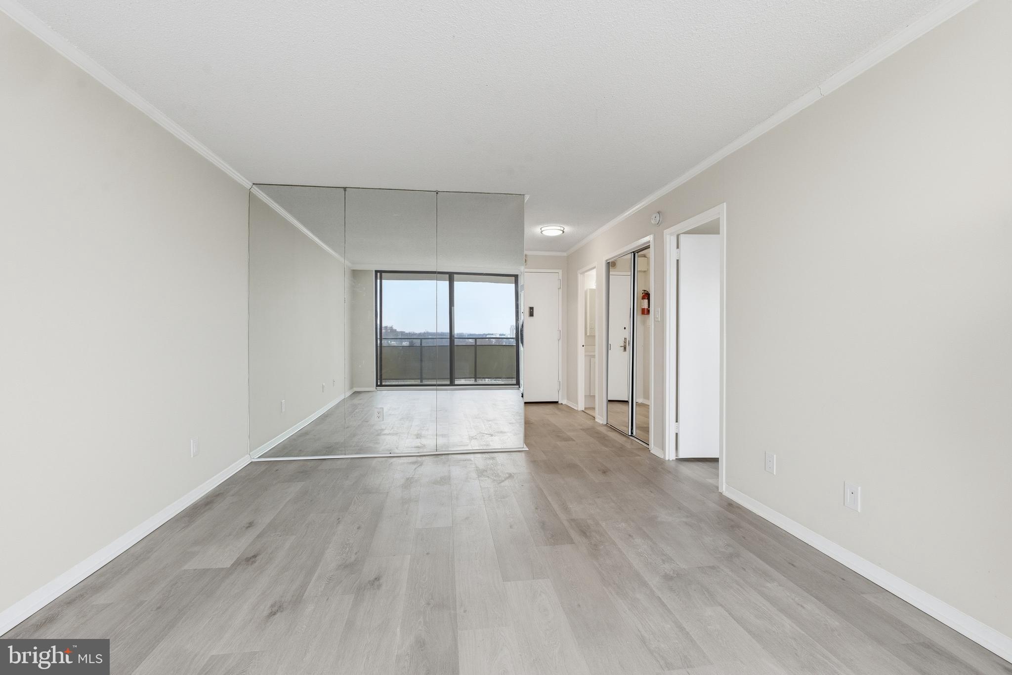 5225 Pooks Hill Road, Unit 1206S Bethesda, MD 20814 - Photo 4 of 12 a view of an empty room with wooden floor and a window