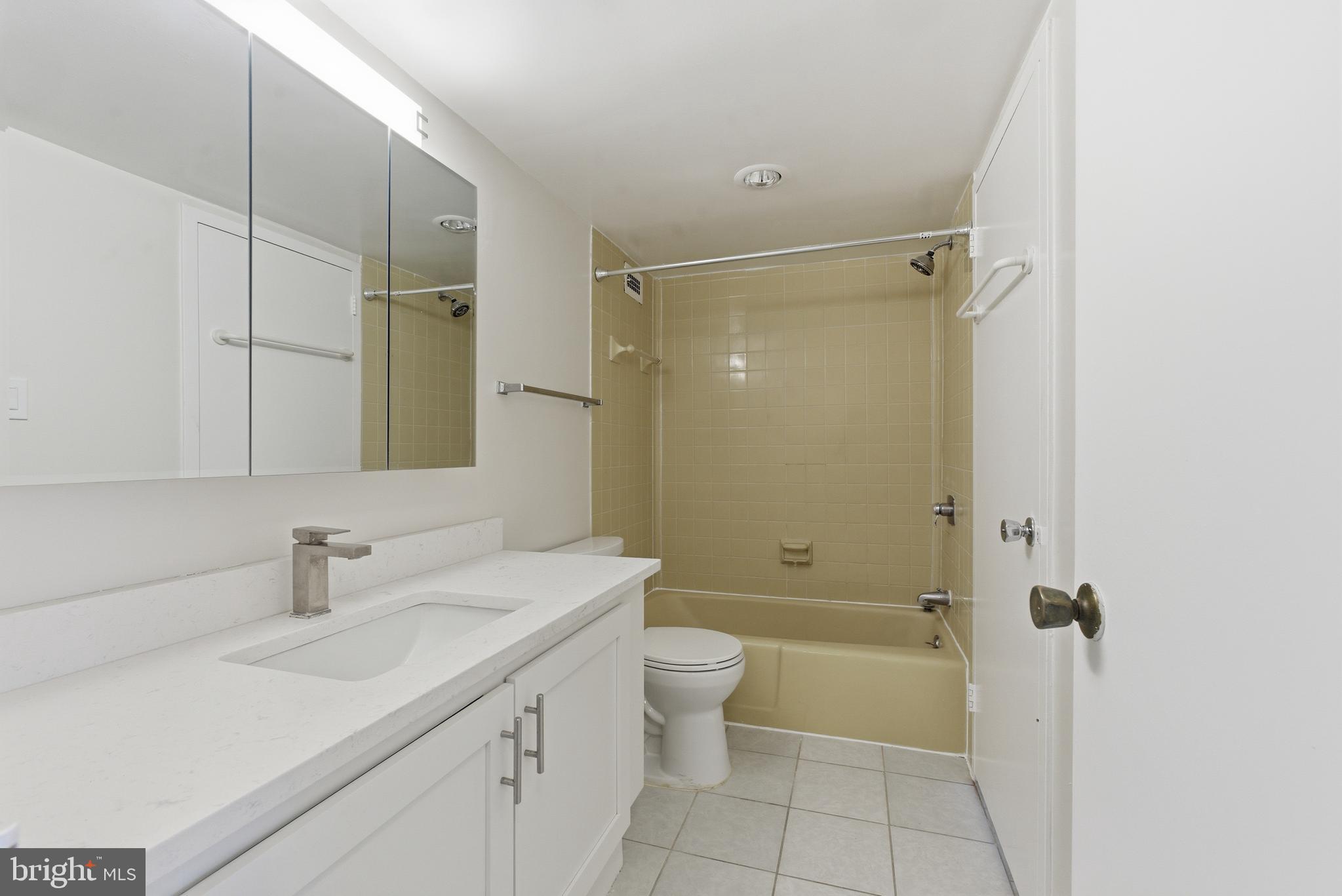 5225 Pooks Hill Road, Unit 1206S Bethesda, MD 20814 - Photo 9 of 12 a bathroom with a sink a toilet and shower