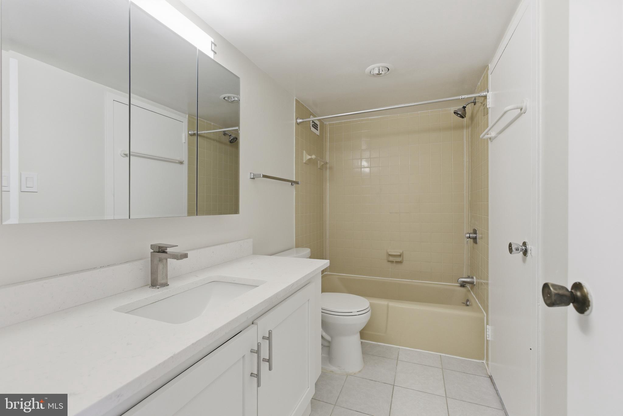 5225 Pooks Hill Road, Unit 1206S Bethesda, MD 20814 - Photo 10 of 12 a bathroom with a sink a toilet and shower