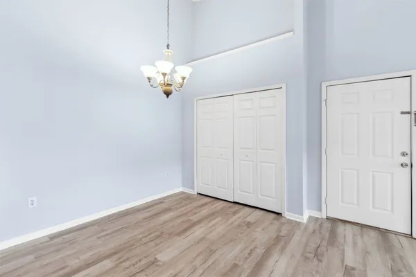 a view of a chandelier fan and wooden floor