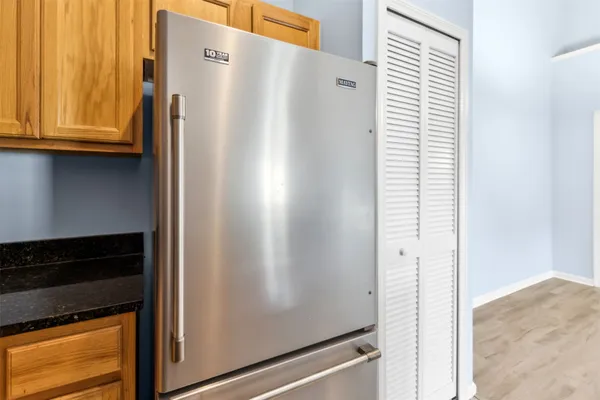 a view of a kitchen with a refrigerator and cabinets