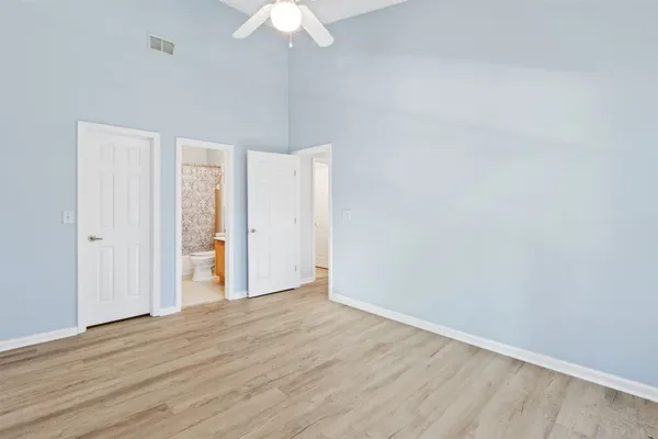 a view of an empty room with wooden floor