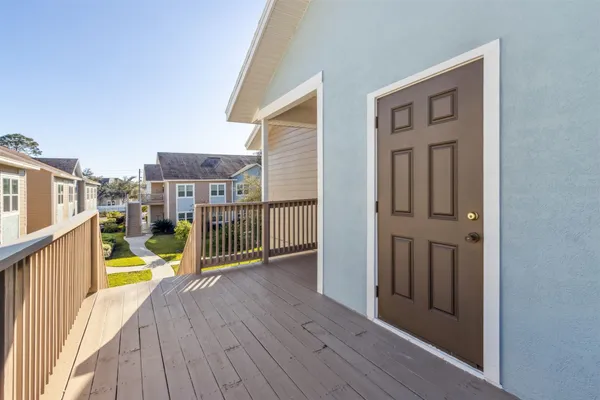 a view of a balcony with wooden floor