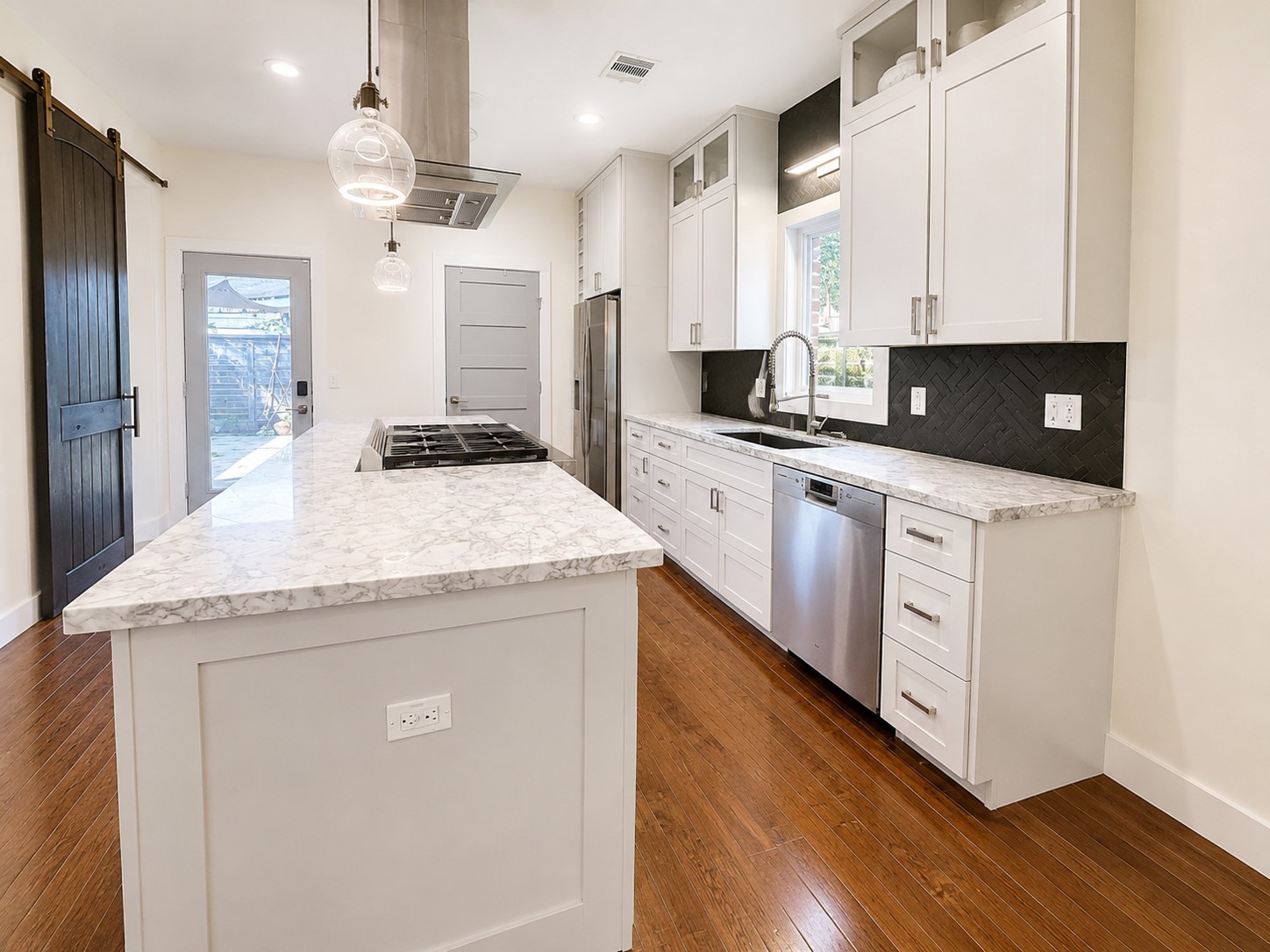 2302 Ruth Street Houston, TX 77004 - Photo 4 of 18 Enjoy the chef's kitchen which offers gas cooking. On the left, the sliding door opens to the step-in pantry. The glass paned door opens in from the back yard.