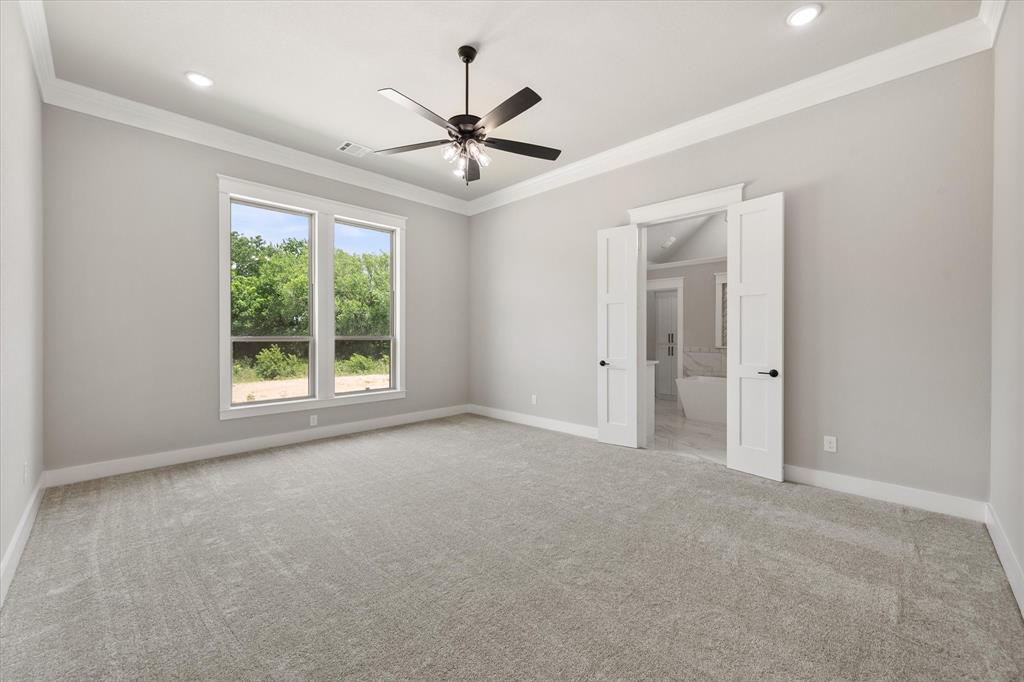 6610 Waggoner Way Midlothian, TX 76065 - Photo 18 of 40 Spacious room featuring light gray carpet, multiple windows, a ceiling fan, recessed lighting, and crown molding