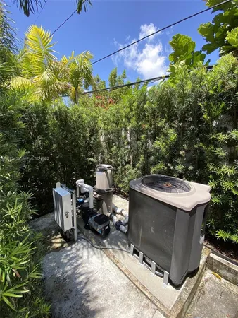 a view of a patio with table and chairs and potted plants