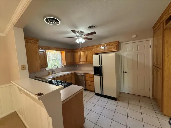 a kitchen with cabinets and stainless steel appliances