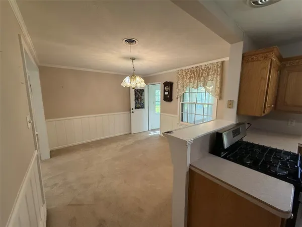a kitchen with a refrigerator a stove a sink and a window