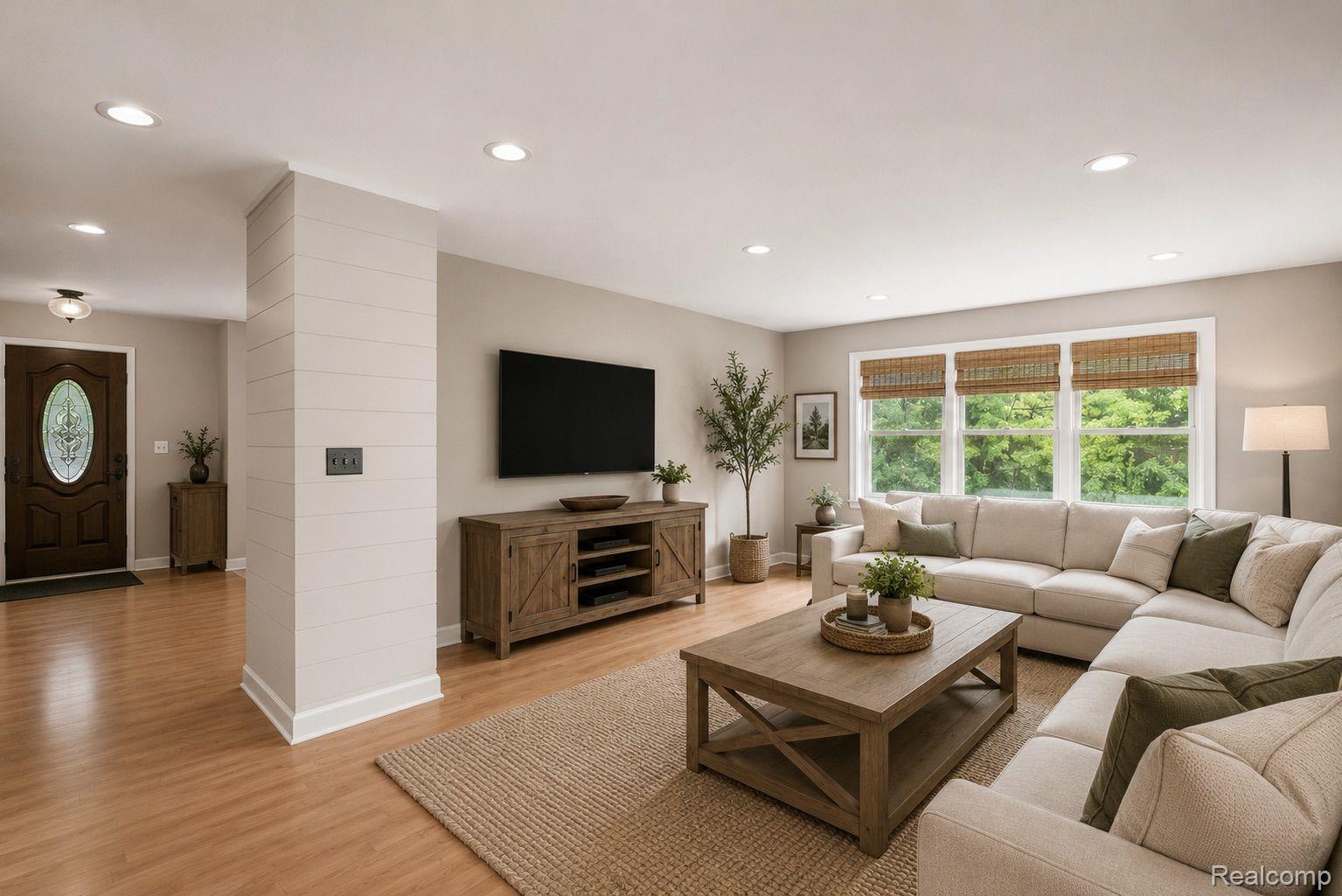 76565 McFadden Road Armada, MI 48005 - Photo 13 of 95 Recessed lighting, light wood-finish flooring, accent shiplap wall, and a wood-paneled entry door with decorative glass insert