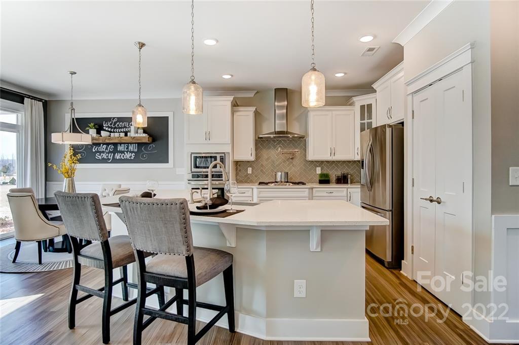 1006 Baldwin Drive Lancaster, SC 29720 - Photo 22 of 48 a kitchen with stainless steel appliances kitchen island a table chairs and a refrigerator