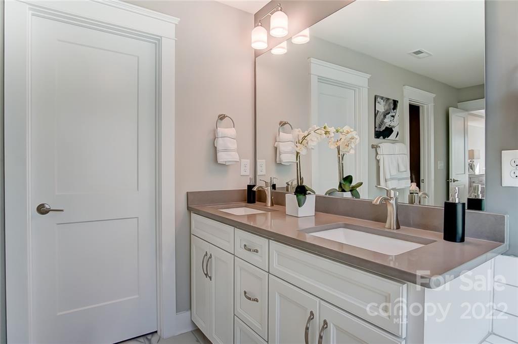 1006 Baldwin Drive Lancaster, SC 29720 - Photo 37 of 48 a bathroom with a granite countertop sink and a mirror