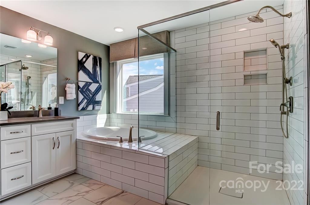 1006 Baldwin Drive Lancaster, SC 29720 - Photo 38 of 48 a bathroom with a tub sink and mirror