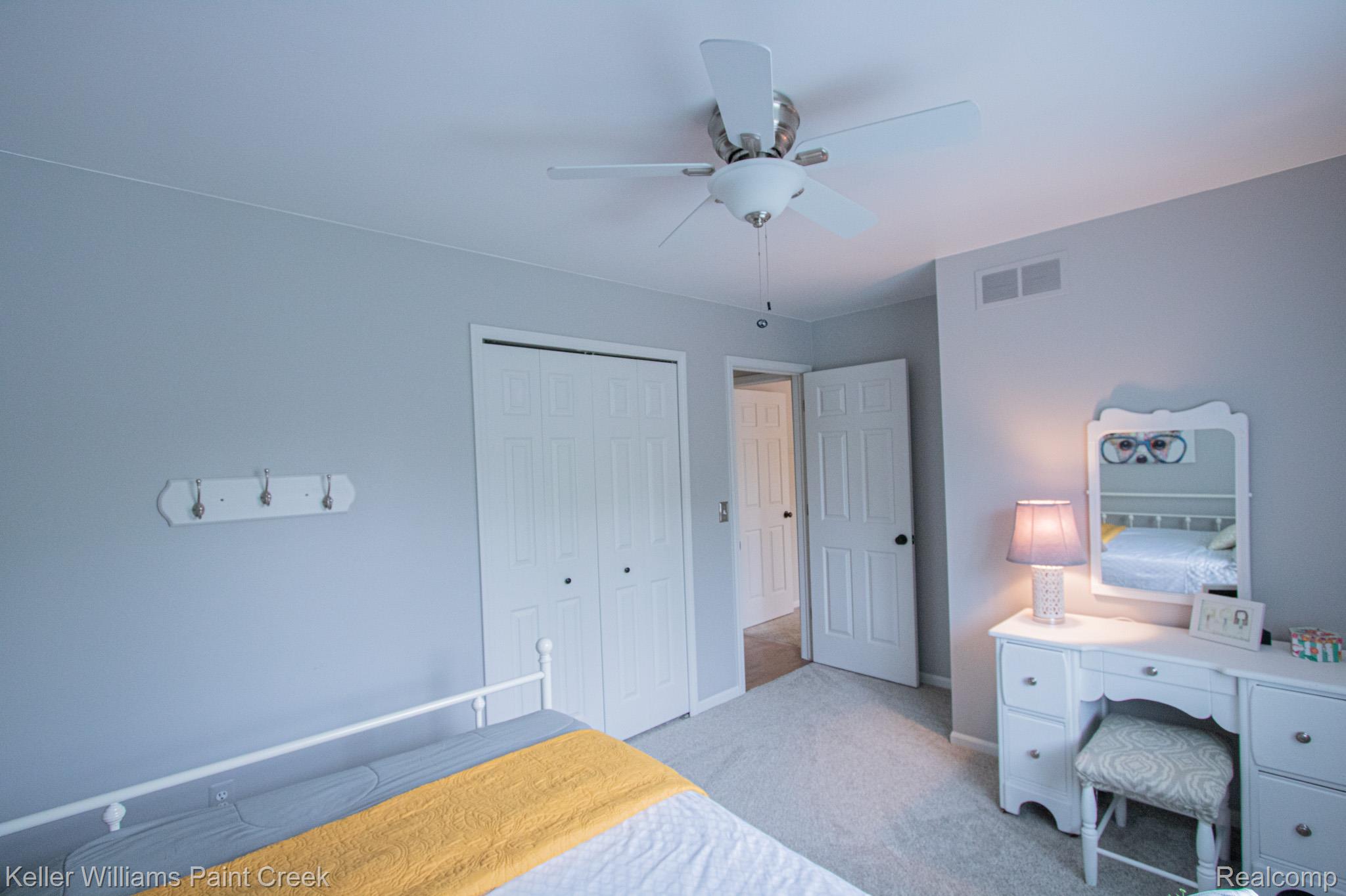 70696 Mellen Street Romeo, MI 48065 - Photo 26 of 46 Bedroom with a closet, light carpet, and ceiling fan