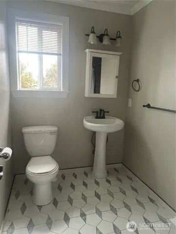 a bathroom with a sink toilet and a mirror