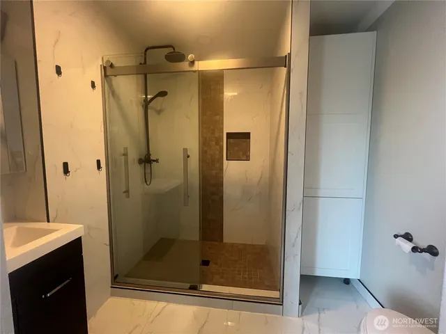 a bathroom with a shower and a sink