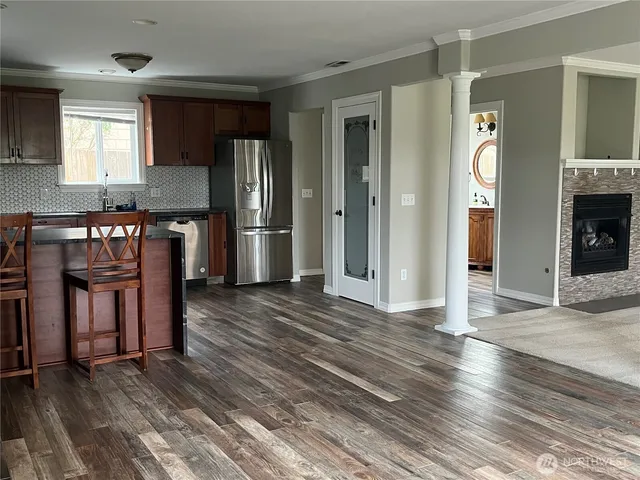 a kitchen with granite countertop wooden floors and stainless steel appliances