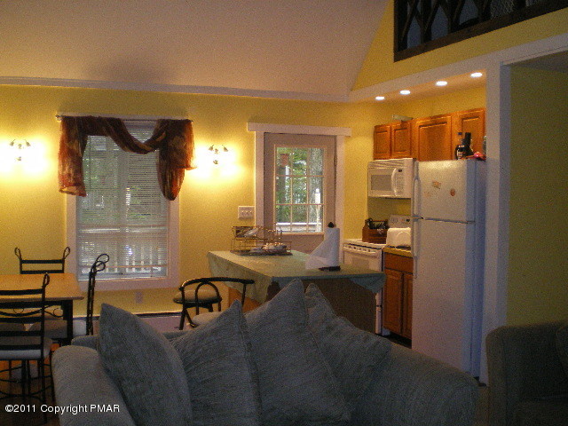 1104 Deer Run Road Pocono Lake, PA 18347 - Photo 2 of 6 a living room with furniture a large window and kitchen view