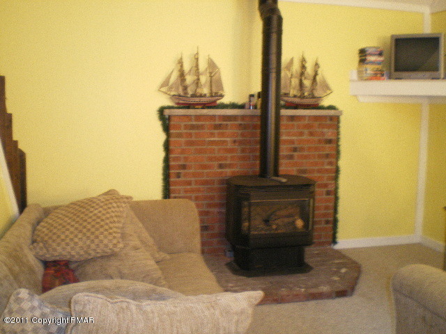 1104 Deer Run Road Pocono Lake, PA 18347 - Photo 3 of 6 a living room with furniture and a fireplace