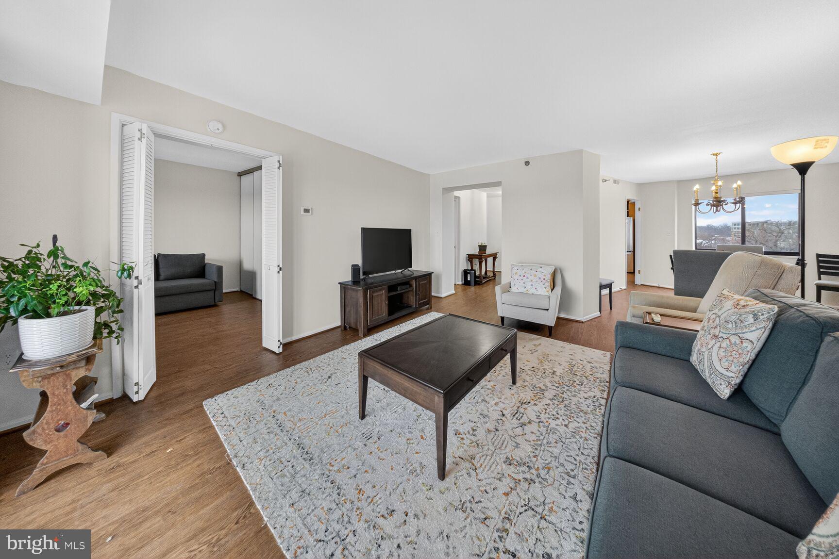 15115 Interlachen Drive, Unit 3812 Silver Spring, MD 20906 - Photo 12 of 46 a living room with furniture and a rug