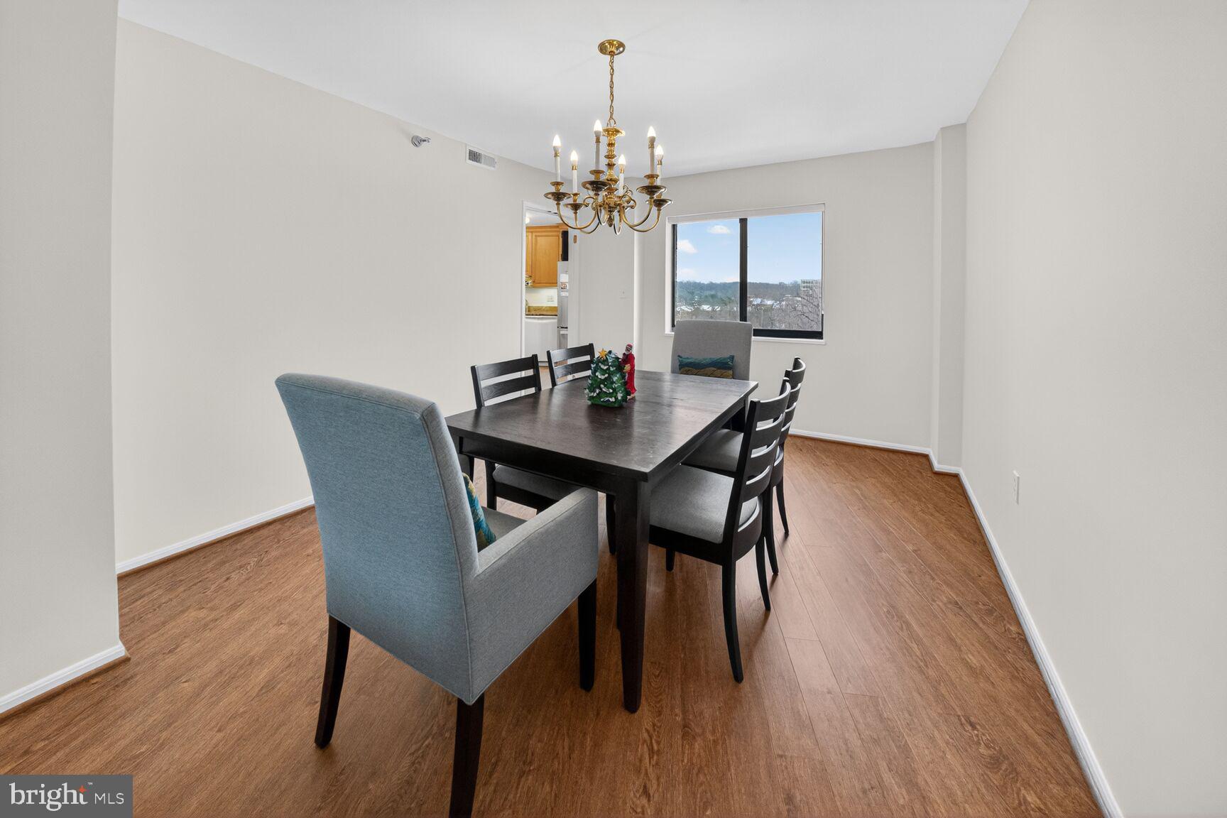 15115 Interlachen Drive, Unit 3812 Silver Spring, MD 20906 - Photo 13 of 46 a view of a dining room with furniture and wooden floor