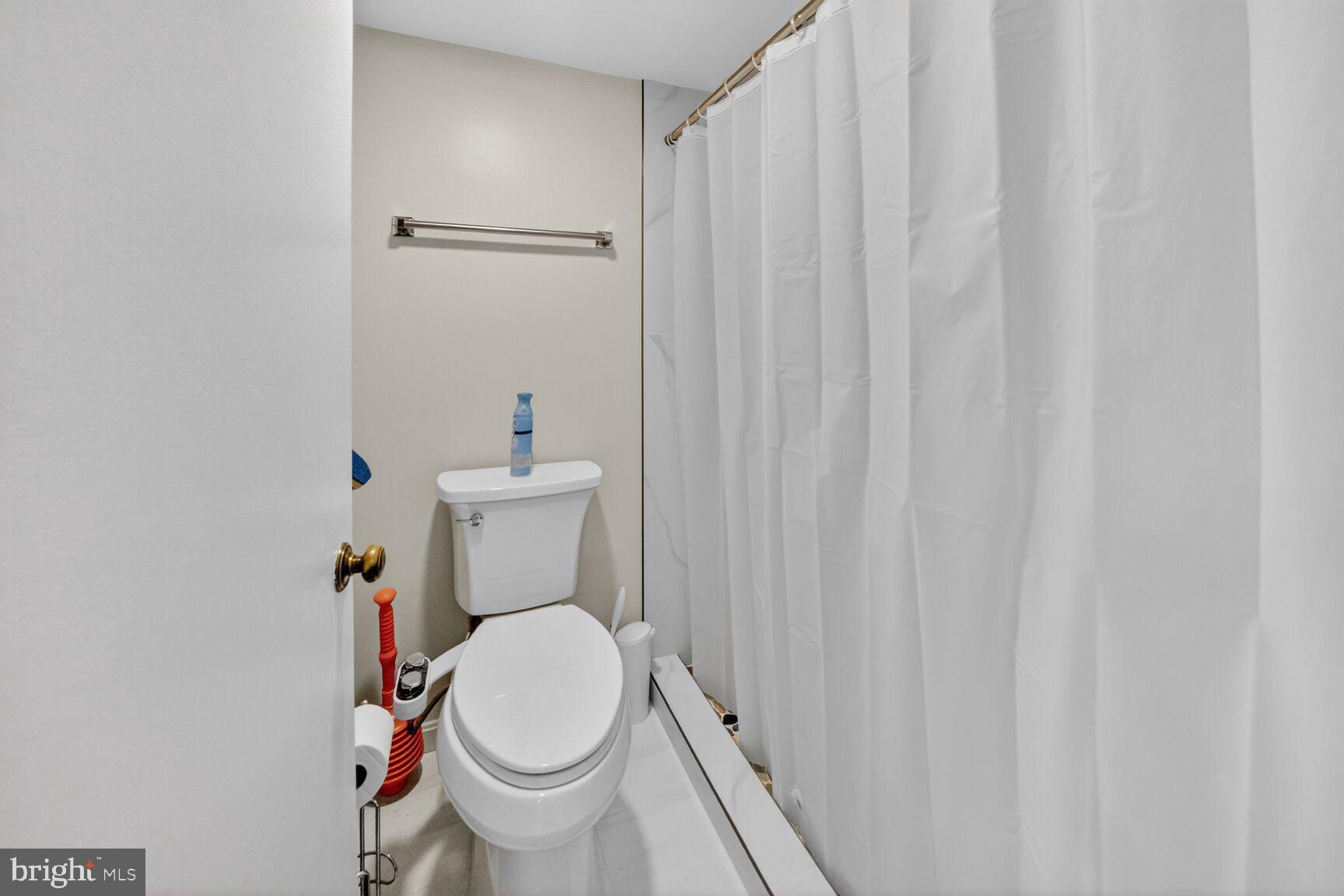 15115 Interlachen Drive, Unit 3812 Silver Spring, MD 20906 - Photo 27 of 46 a white toilet sitting next to a small sink