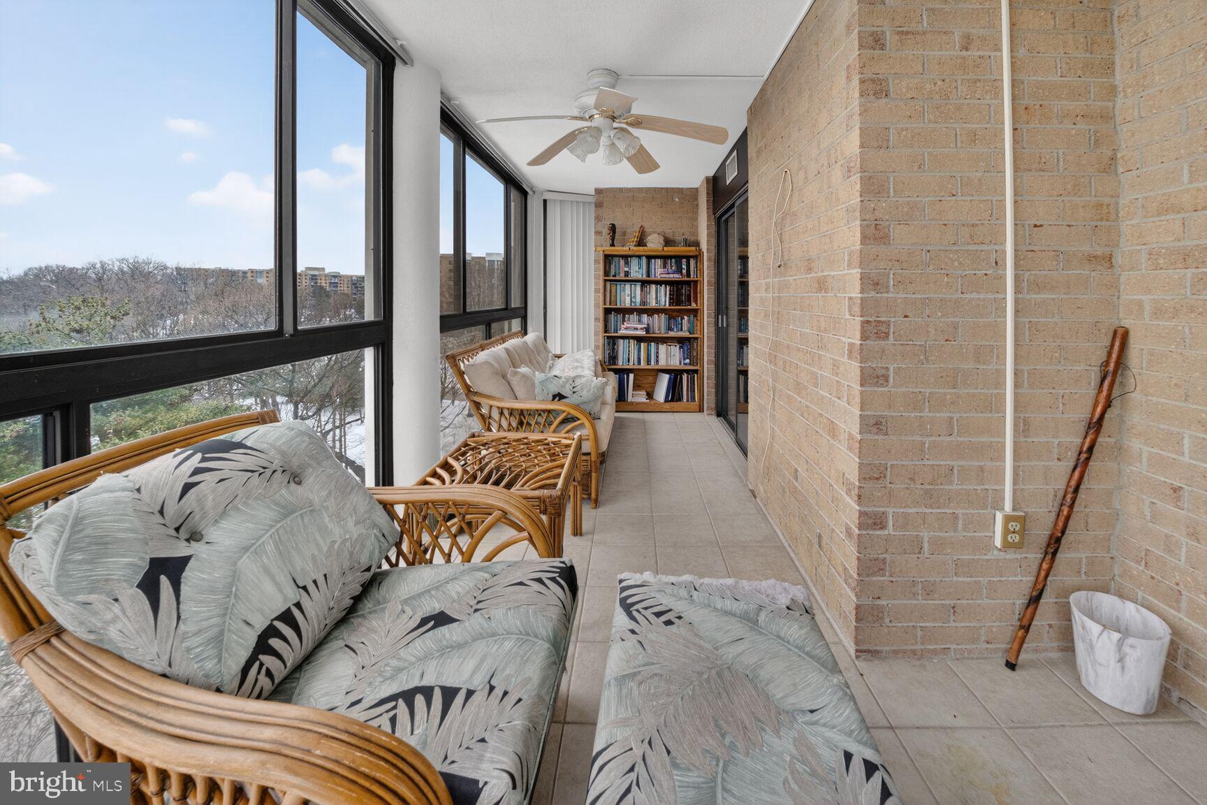 15115 Interlachen Drive, Unit 3812 Silver Spring, MD 20906 - Photo 30 of 46 a living room with furniture and a floor to ceiling window