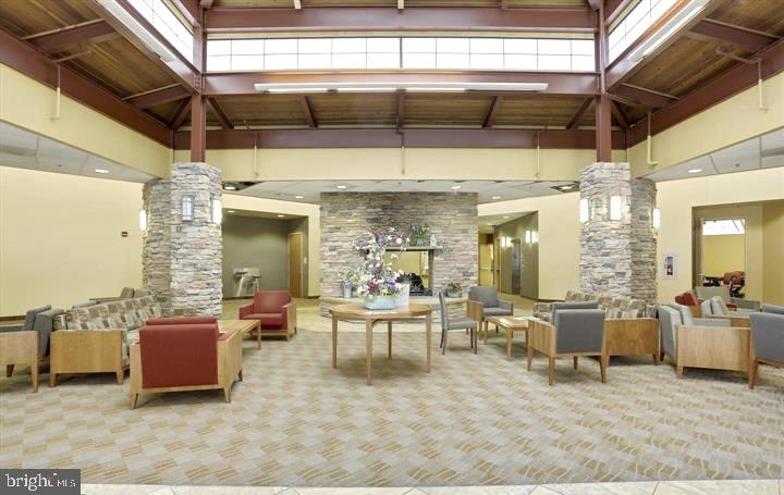 15115 Interlachen Drive, Unit 3812 Silver Spring, MD 20906 - Photo 38 of 46 a living room with furniture and a chandelier