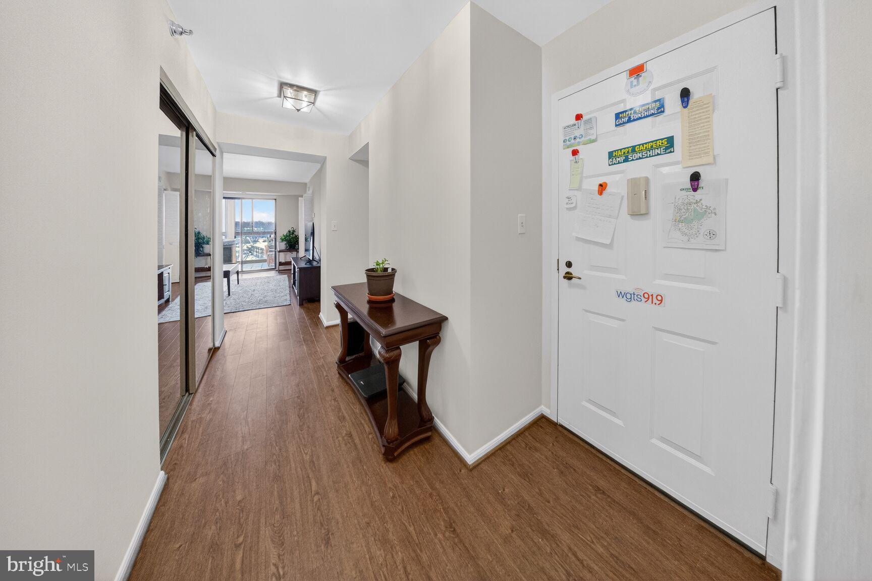 15115 Interlachen Drive, Unit 3812 Silver Spring, MD 20906 - Photo 7 of 46 a view of a hallway with wooden floor and a workspace