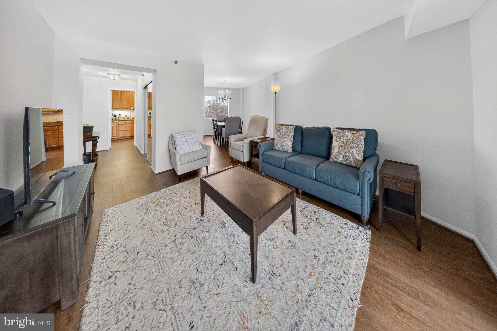 15115 Interlachen Drive, Unit 3812 Silver Spring, MD 20906 - Photo 10 of 46 a living room with furniture and a flat screen tv